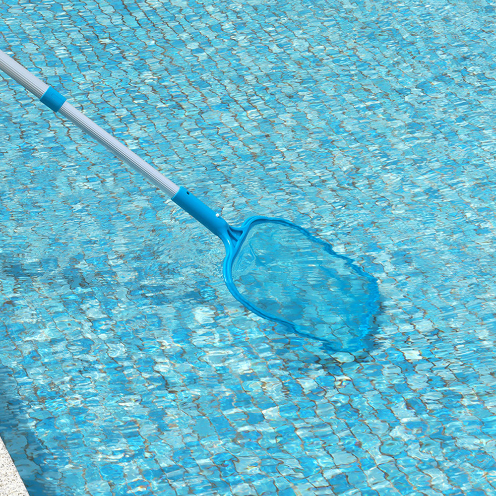 Manual pool skimmer in use